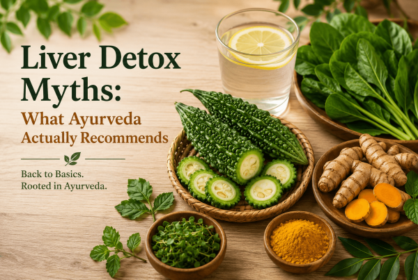 Flatlay of bitter gourd, turmeric root, leafy greens, and a glass of warm lemon water on a wooden table, illustrating Ayurvedic recommendations for liver health and natural nutrition over detox myths.